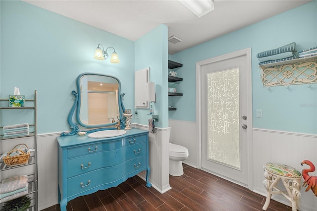 bathroom featuring toilet, vanity, and wood-type flooring