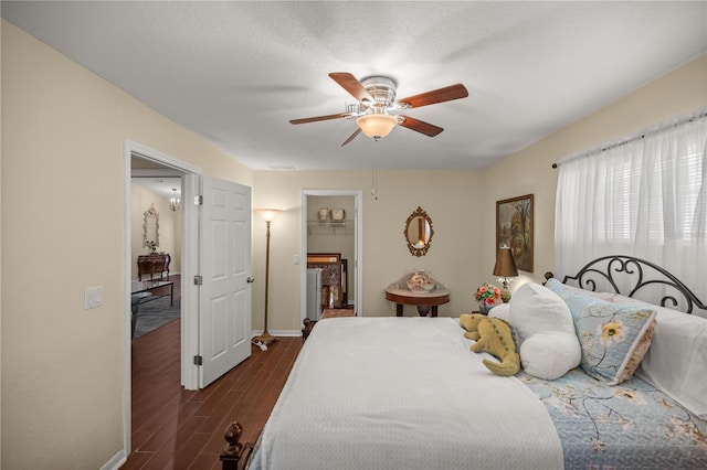 bedroom with ceiling fan and dark hardwood / wood-style floors