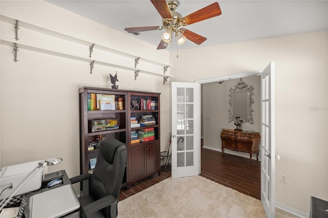 office with dark hardwood / wood-style flooring, ceiling fan, and french doors