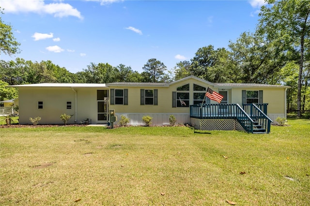 view of front facade with a front yard and a deck