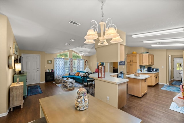 dining space featuring ceiling fan with notable chandelier and dark hardwood / wood-style floors