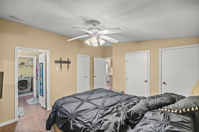 bedroom featuring light hardwood / wood-style floors, a textured ceiling, ceiling fan, and washer / dryer