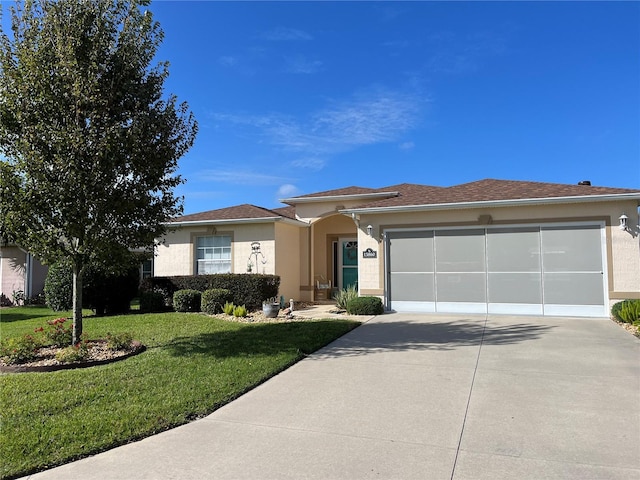 view of front of house with a garage and a front lawn