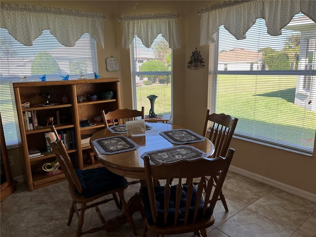 tiled dining room with a healthy amount of sunlight