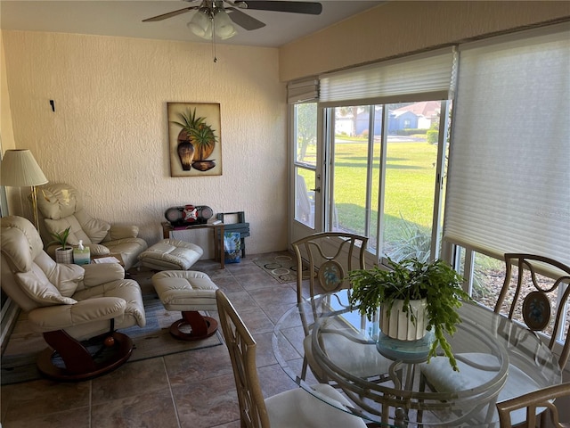 interior space with ceiling fan