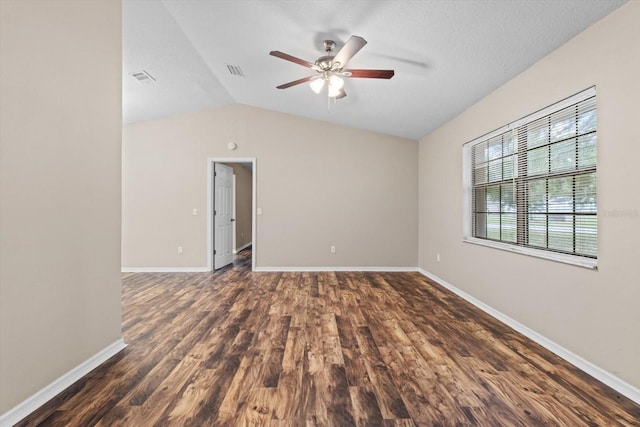 spare room featuring ceiling fan, dark hardwood / wood-style floors, a textured ceiling, and vaulted ceiling