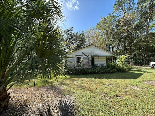 view of home's exterior with a yard