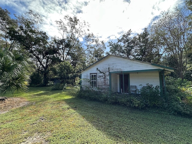 view of side of home featuring a lawn