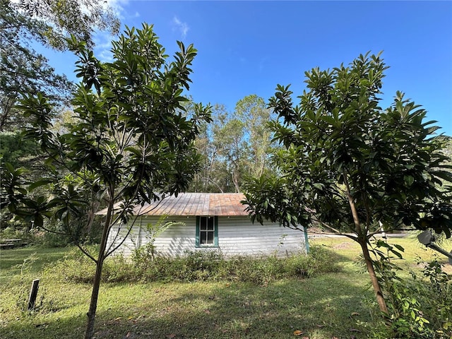 view of side of home with a lawn