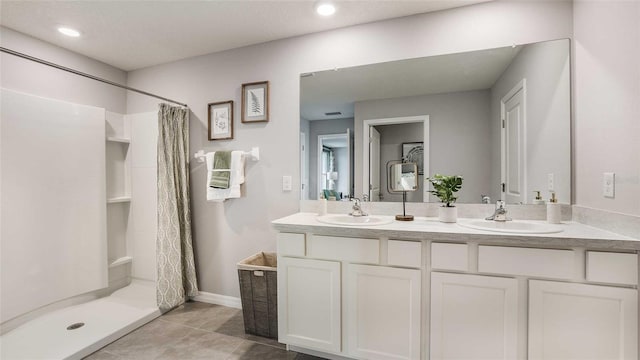 bathroom featuring vanity, tile patterned flooring, and curtained shower