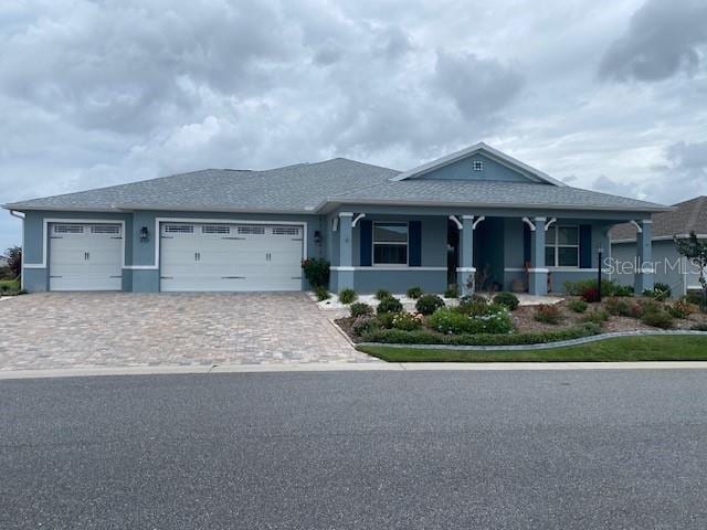 view of front of property featuring a garage and a porch