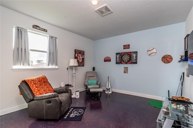 sitting room featuring a textured ceiling