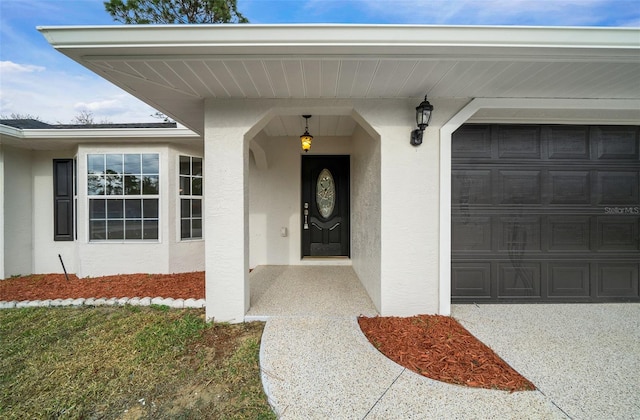 view of exterior entry with a garage