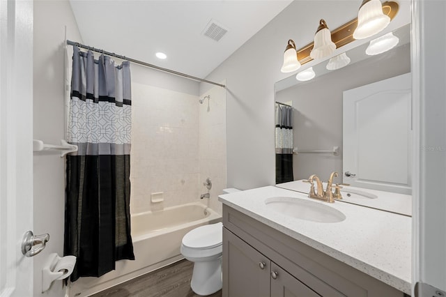 full bathroom with shower / tub combo with curtain, vanity, wood-type flooring, and toilet