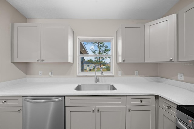 kitchen featuring appliances with stainless steel finishes, gray cabinets, and sink