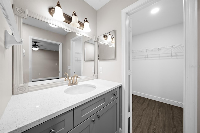 bathroom with ceiling fan, hardwood / wood-style floors, and vanity