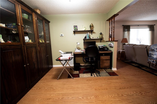 office space with light hardwood / wood-style floors and a textured ceiling