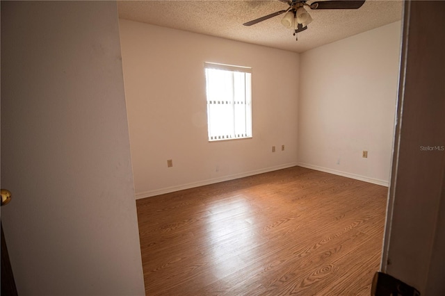 spare room featuring a textured ceiling, light hardwood / wood-style flooring, and ceiling fan