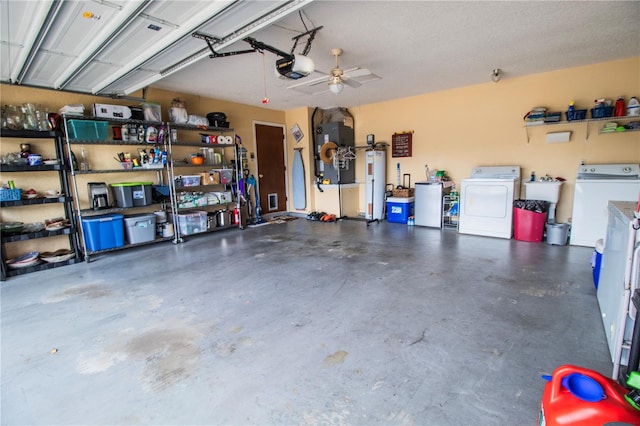 garage featuring ceiling fan, gas water heater, independent washer and dryer, heating unit, and a garage door opener