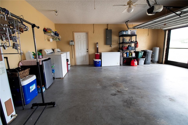 garage with electric panel, ceiling fan, a garage door opener, and independent washer and dryer