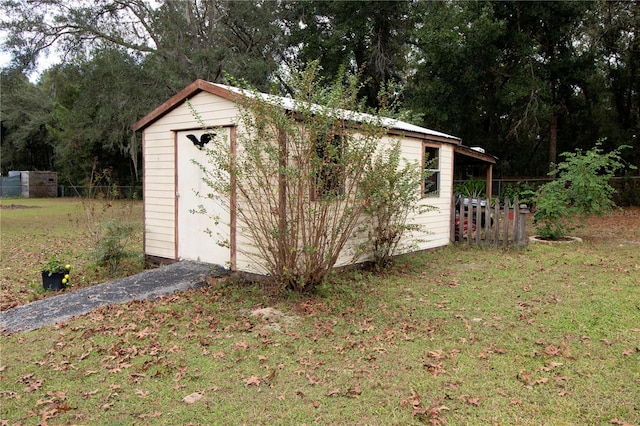 view of outbuilding featuring a yard