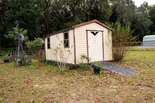 view of outdoor structure featuring a lawn