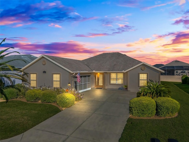 ranch-style home with a lawn