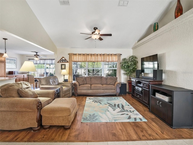 living room featuring ceiling fan, hardwood / wood-style floors, and high vaulted ceiling