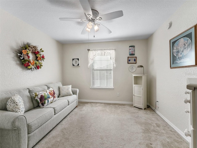 carpeted living room with ceiling fan and a textured ceiling