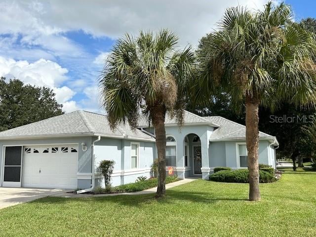 single story home with a garage and a front lawn