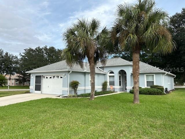 single story home with a front yard and a garage