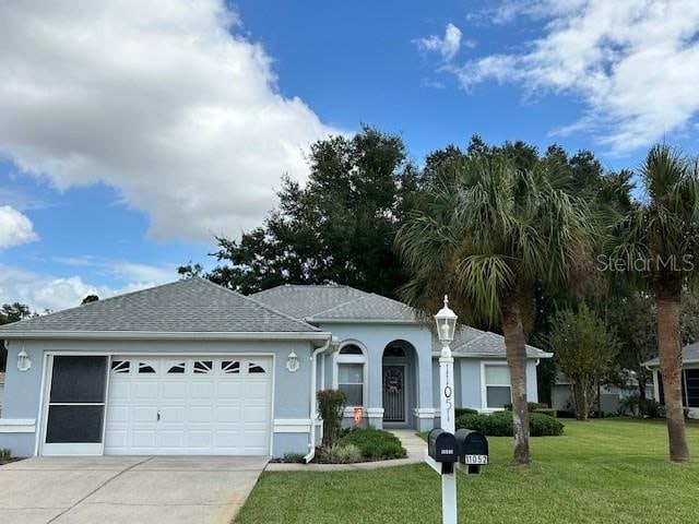 single story home with a front lawn and a garage