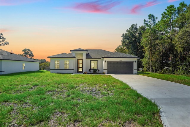 view of front of home with a lawn and a garage