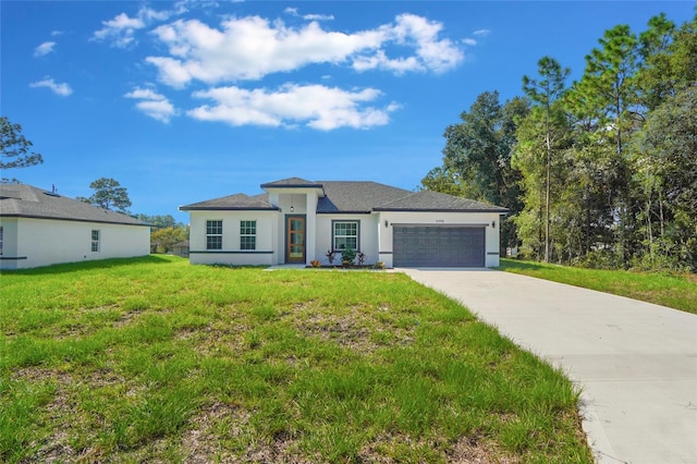 view of front of property featuring a garage and a front lawn