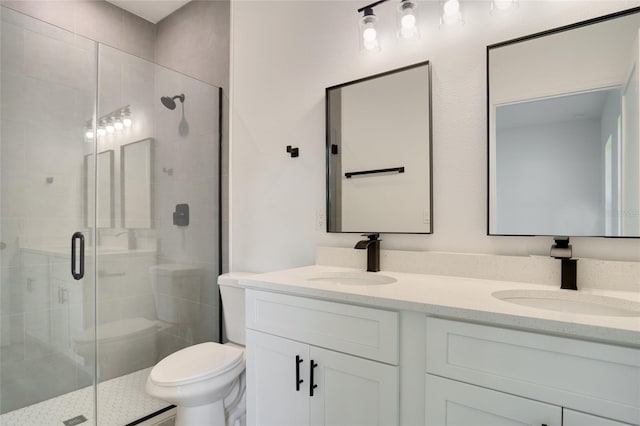 bathroom featuring a shower with door, vanity, and toilet