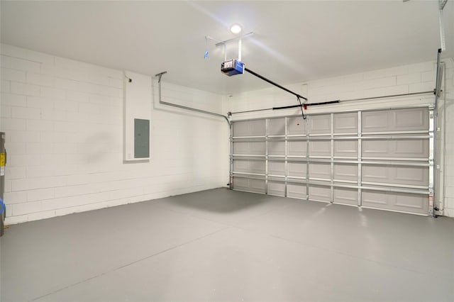 garage featuring electric panel and a garage door opener