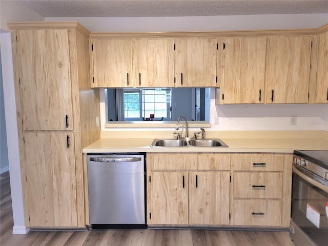 kitchen with light brown cabinets, hardwood / wood-style flooring, sink, and appliances with stainless steel finishes