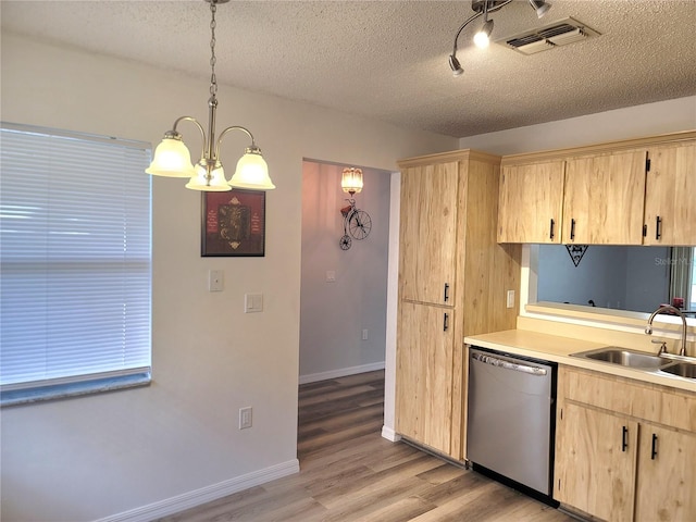 kitchen featuring sink, stainless steel dishwasher, pendant lighting, light hardwood / wood-style flooring, and light brown cabinetry