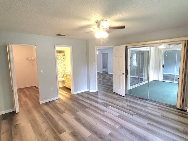 interior space featuring ceiling fan, a textured ceiling, and light hardwood / wood-style flooring