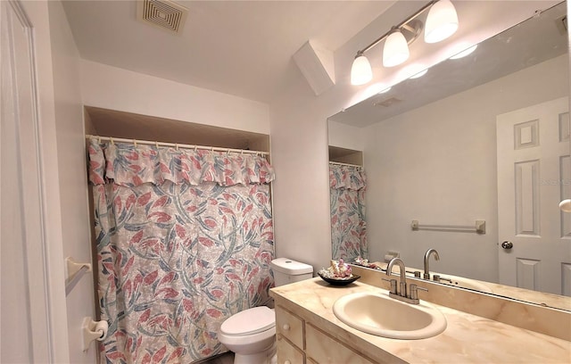 bathroom featuring toilet and vanity