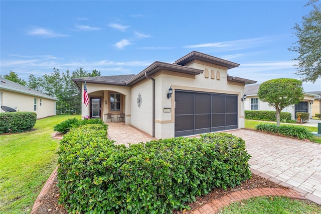 view of front of property with a garage and a front lawn