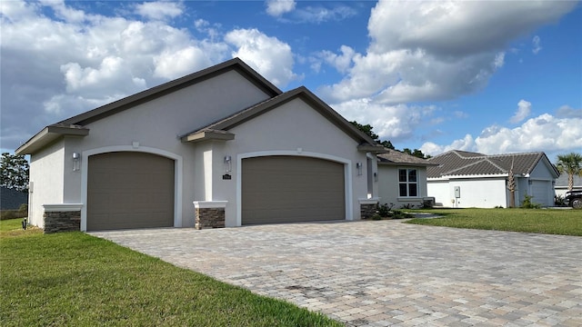 view of front facade with a front yard and a garage