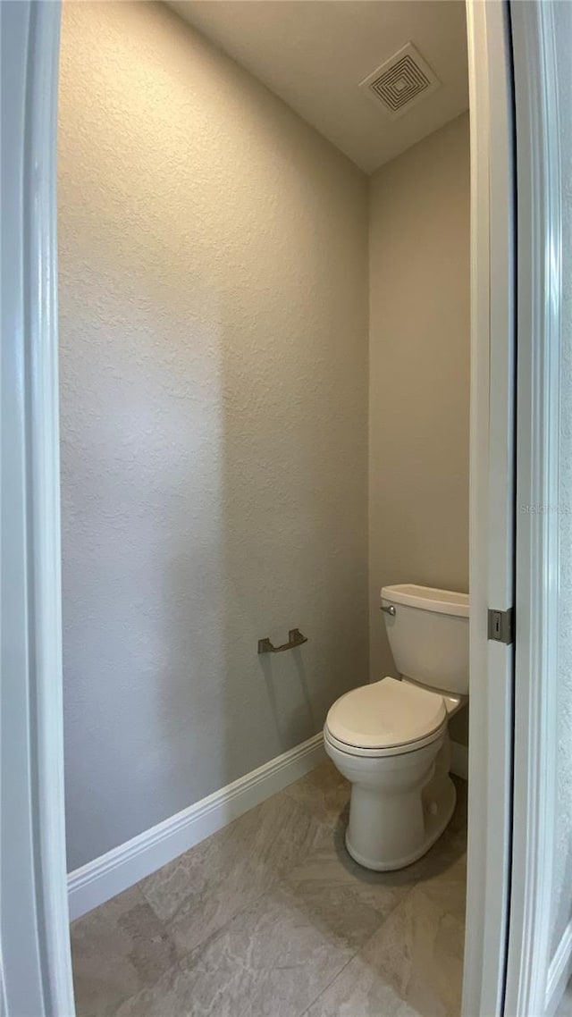 bathroom featuring tile patterned flooring and toilet