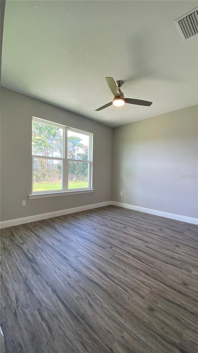 empty room featuring ceiling fan and dark hardwood / wood-style floors