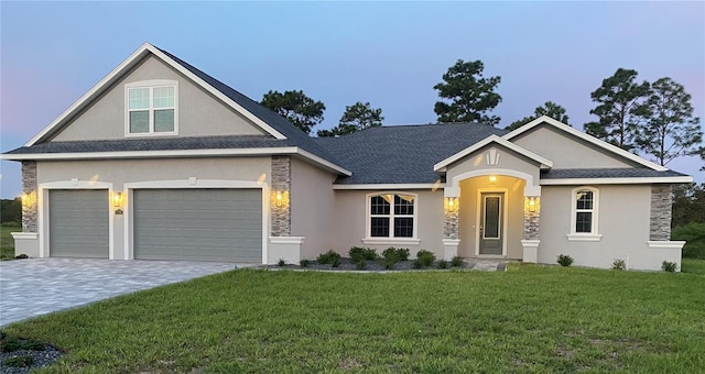 view of front of home featuring a lawn and a garage