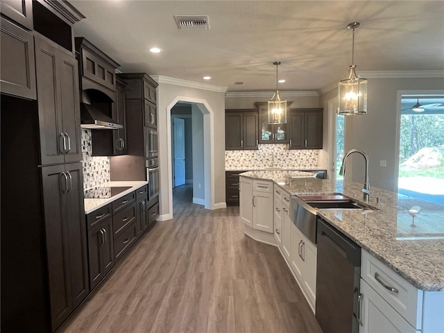 kitchen with a sink, visible vents, white cabinets, black appliances, and glass insert cabinets