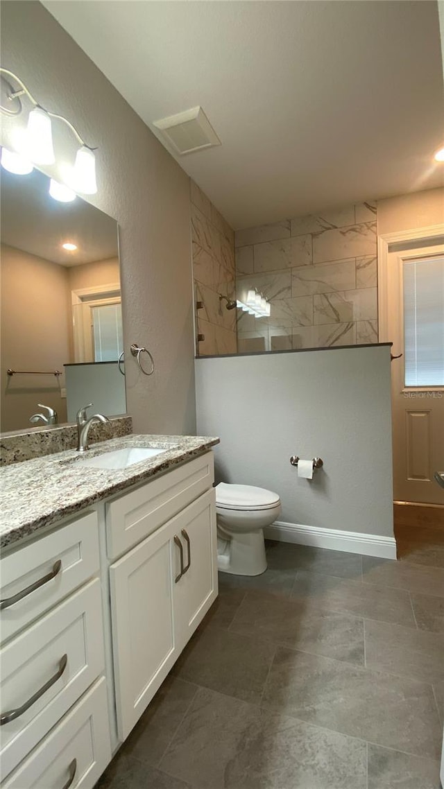 full bath with toilet, visible vents, walk in shower, and vanity