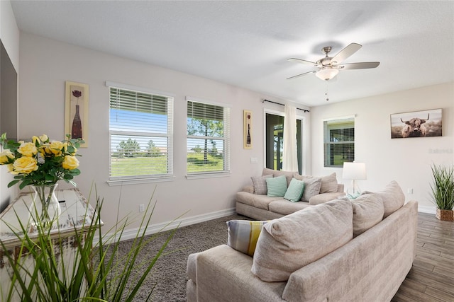 living room featuring dark hardwood / wood-style flooring and ceiling fan