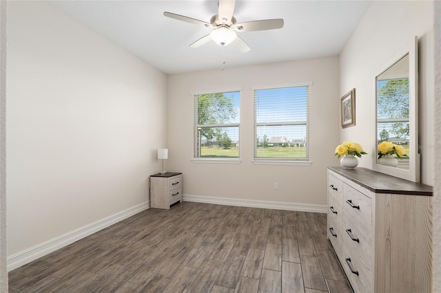 unfurnished bedroom with dark hardwood / wood-style flooring and ceiling fan