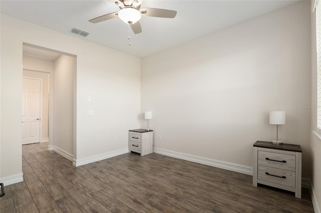 unfurnished room with ceiling fan and dark hardwood / wood-style floors